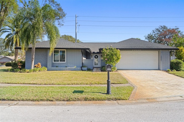 ranch-style home featuring a garage and a front yard