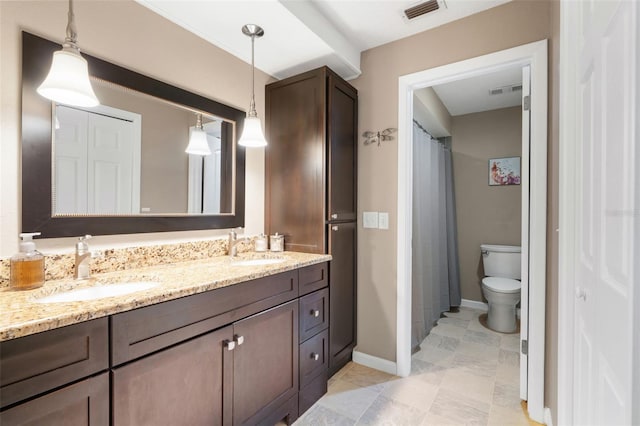 bathroom featuring vanity and toilet