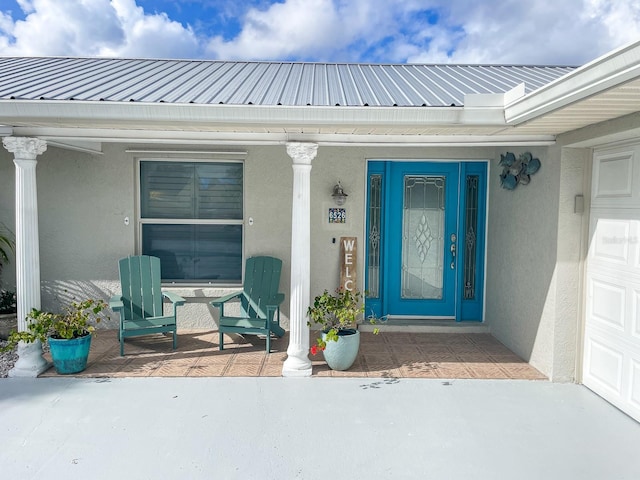 view of exterior entry with covered porch