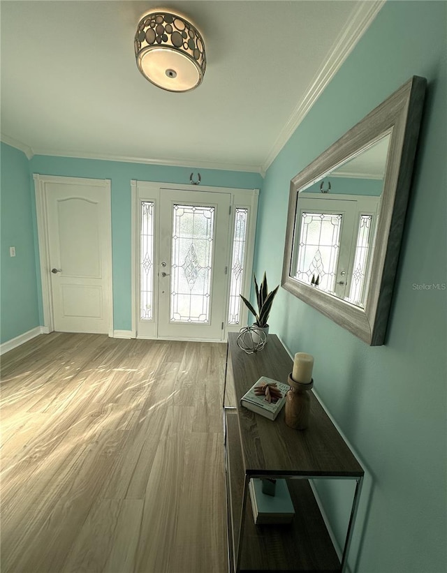 entryway with wood-type flooring and crown molding