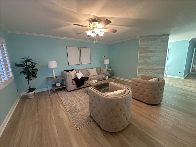 living room with ceiling fan, light hardwood / wood-style flooring, and ornamental molding