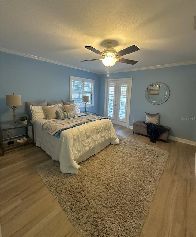 bedroom with access to outside, ceiling fan, crown molding, and wood-type flooring