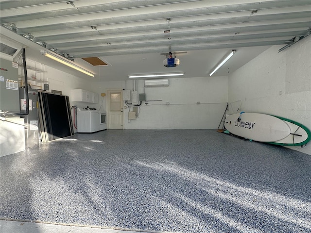 garage featuring electric water heater, a garage door opener, and washing machine and clothes dryer