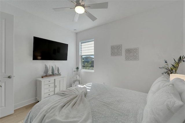 bedroom with light wood-type flooring and ceiling fan