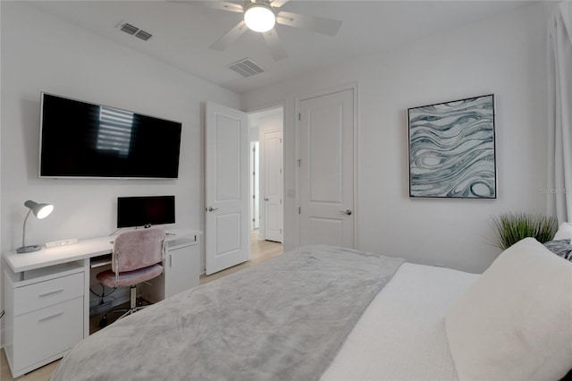 bedroom with built in desk and ceiling fan