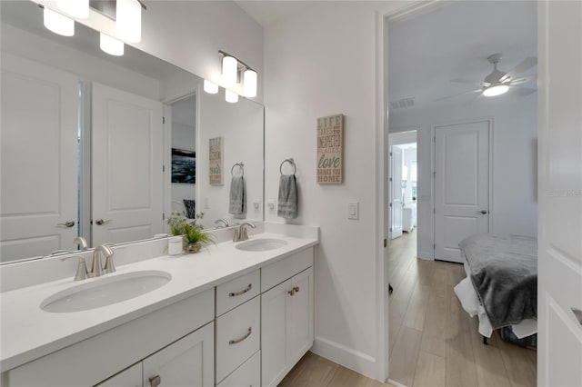 bathroom featuring ceiling fan, hardwood / wood-style floors, and vanity