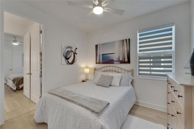 bedroom with light hardwood / wood-style floors and ceiling fan