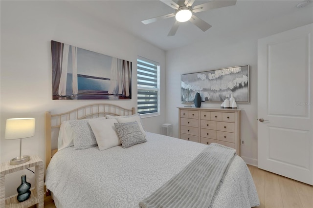 bedroom with ceiling fan and light hardwood / wood-style floors