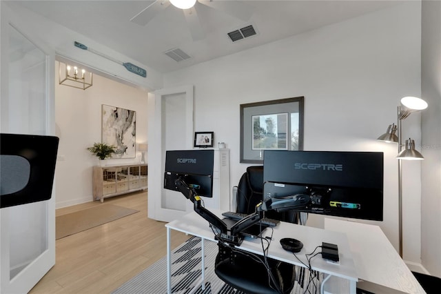 home office featuring french doors, hardwood / wood-style floors, and ceiling fan with notable chandelier