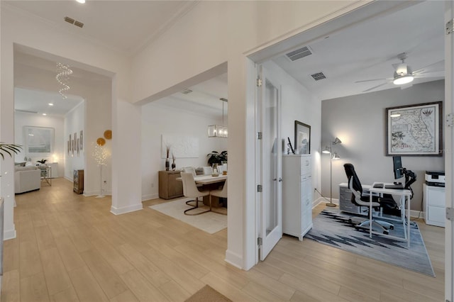 home office with light hardwood / wood-style flooring, ceiling fan with notable chandelier, and ornamental molding