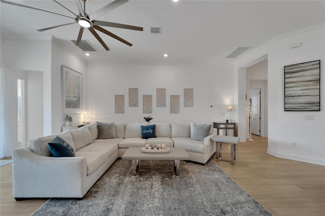 living room with crown molding and light hardwood / wood-style flooring