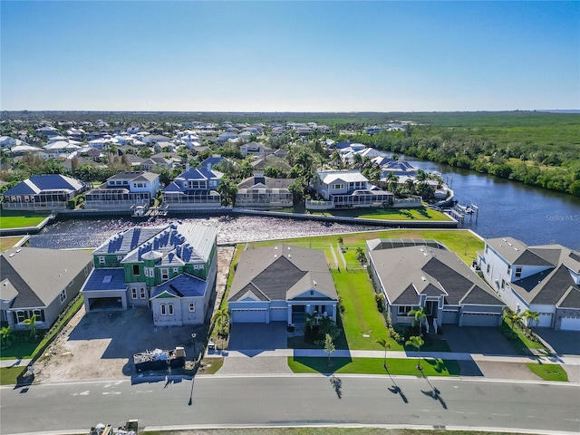 birds eye view of property featuring a water view and a residential view