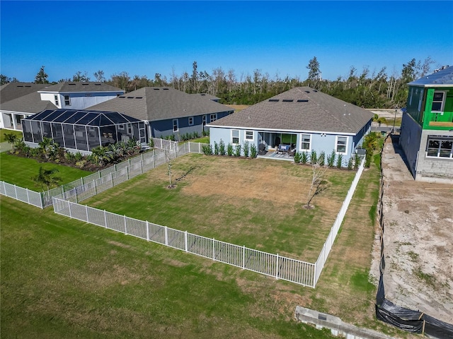 back of property featuring glass enclosure, a fenced backyard, and a residential view