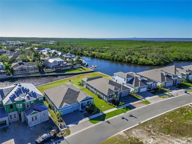 bird's eye view with a water view, a residential view, and a view of trees