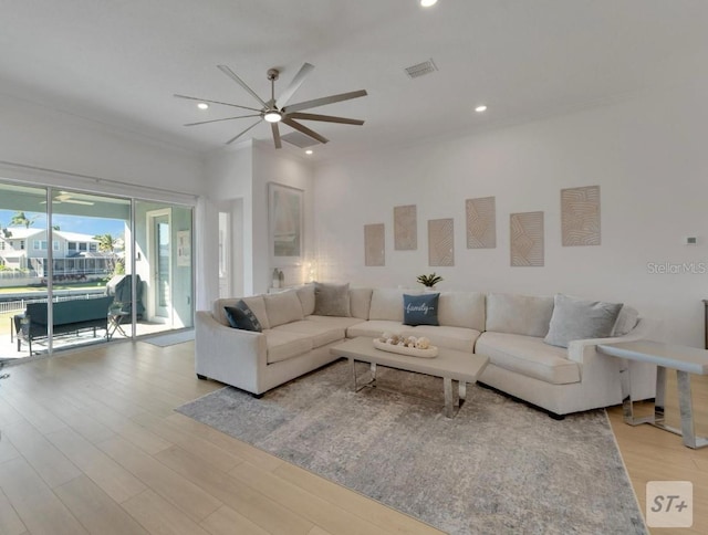 living area featuring wood finished floors, a ceiling fan, and recessed lighting