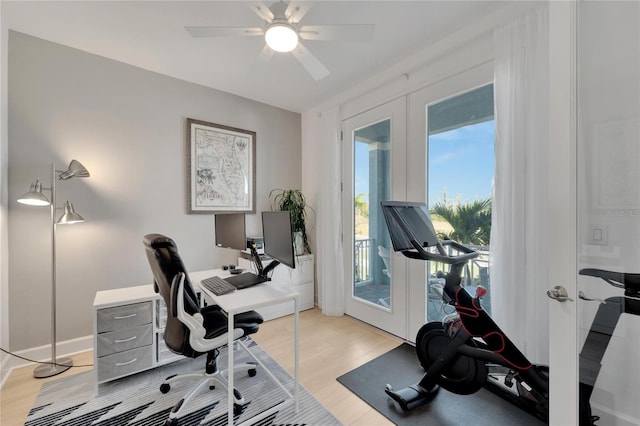 office space featuring light wood-type flooring, a ceiling fan, and french doors