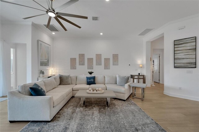 living area featuring ornamental molding, a ceiling fan, light wood-style flooring, recessed lighting, and baseboards
