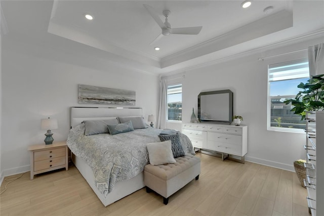 bedroom with a tray ceiling, ornamental molding, light wood-style flooring, baseboards, and recessed lighting
