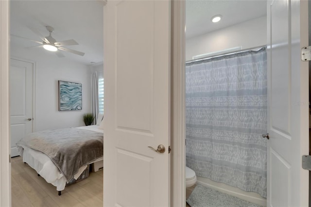 bedroom with light wood-style flooring and a ceiling fan