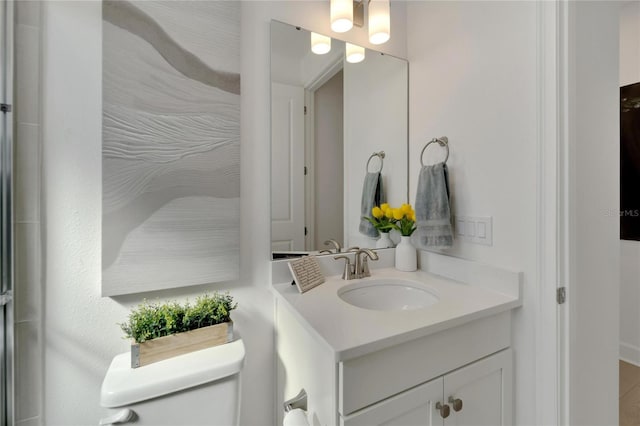 bathroom with toilet and vanity