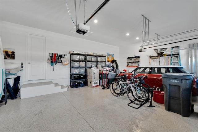 garage featuring a garage door opener and recessed lighting