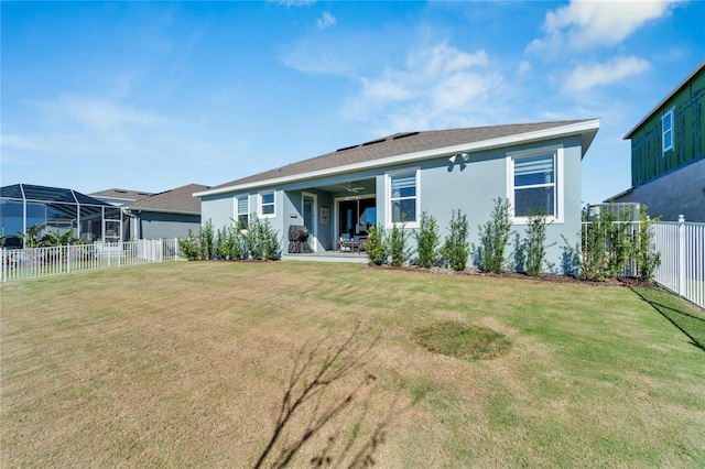 back of house featuring stucco siding and a ceiling fan