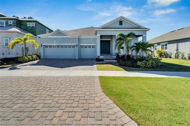 view of front of property featuring decorative driveway, a front lawn, a garage, a porch, and stucco siding