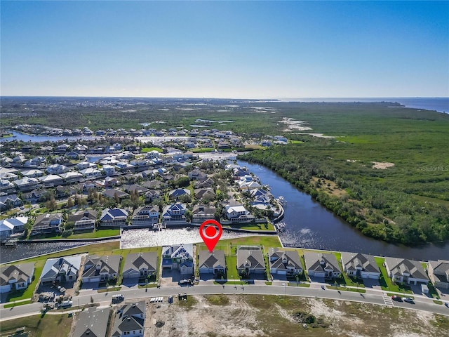 aerial view of residential area featuring a large body of water