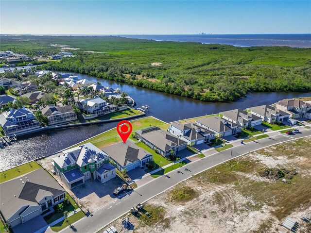 bird's eye view featuring a water view, a forest view, and a residential view