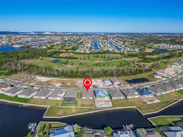 view of property location featuring a nearby body of water and nearby suburban area