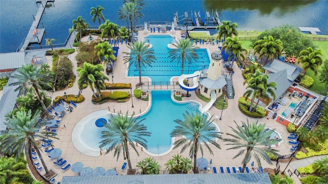 drone / aerial view of a pool and a large body of water