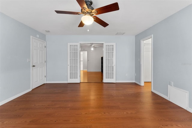 spare room with hardwood / wood-style flooring and french doors