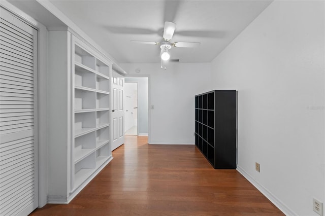 interior space with ceiling fan, wood-type flooring, and built in features