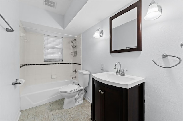 full bathroom featuring toilet, vanity, and tiled shower / bath