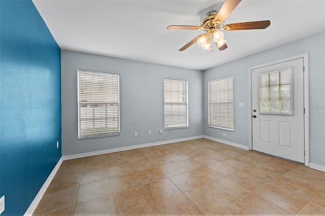 interior space with ceiling fan