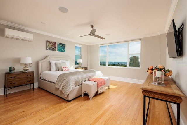 bedroom with a wall unit AC, ceiling fan, light hardwood / wood-style floors, and ornamental molding