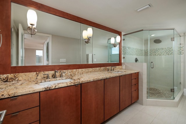 bathroom with tile patterned flooring, vanity, and an enclosed shower