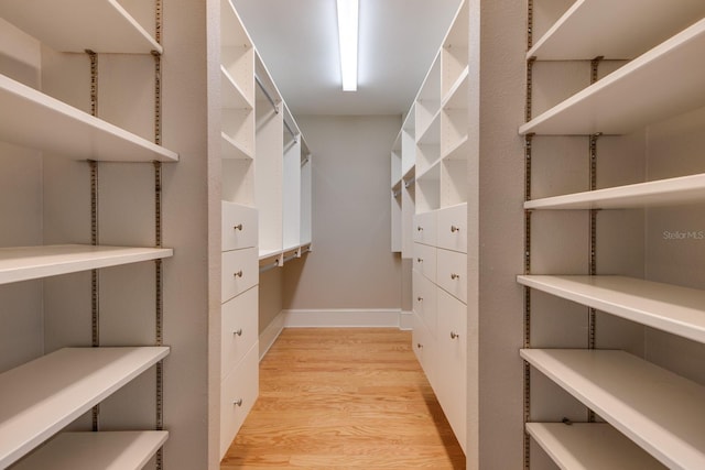 spacious closet with light hardwood / wood-style flooring