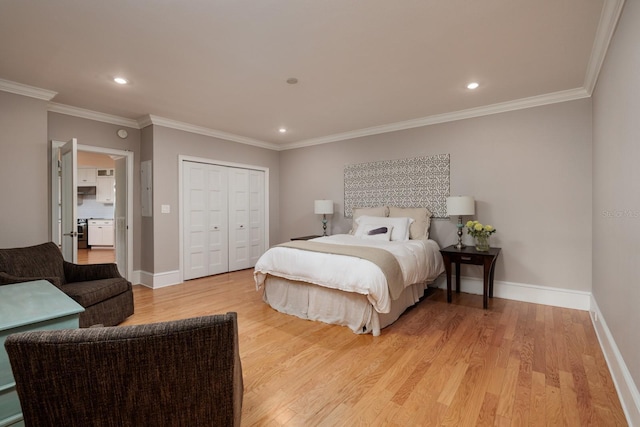 bedroom with a closet, light hardwood / wood-style floors, and ornamental molding