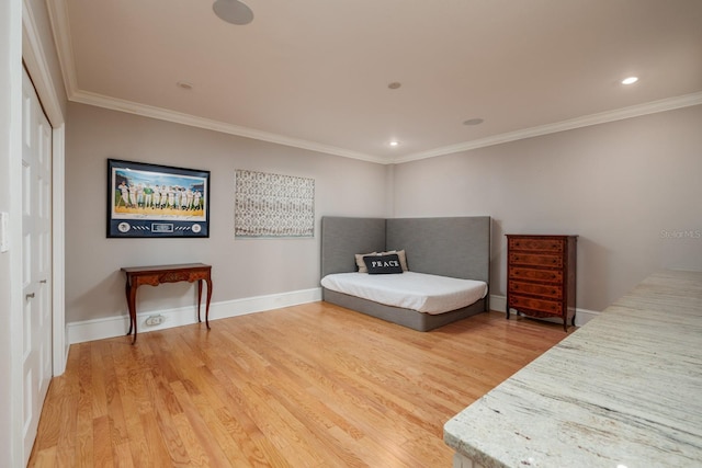 bedroom featuring hardwood / wood-style flooring, a closet, and ornamental molding