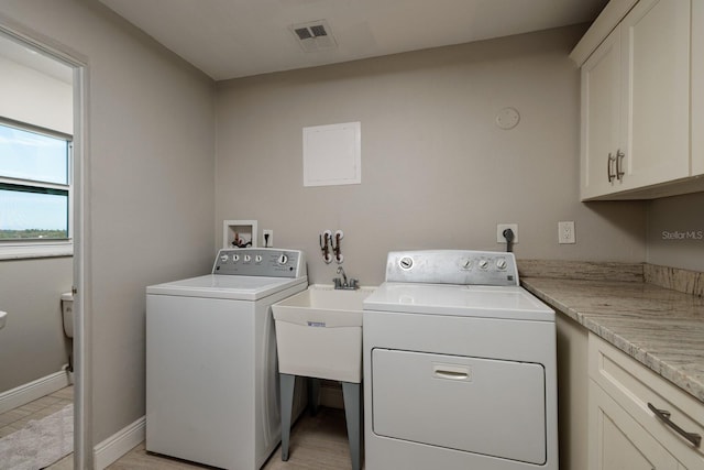 laundry area featuring cabinets and washer and clothes dryer