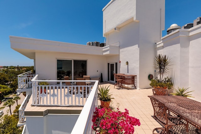 back of property featuring a balcony and a patio area