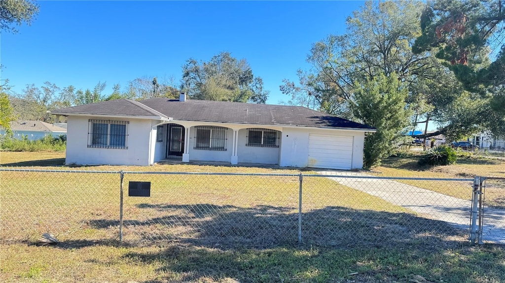 single story home with a front yard and a garage