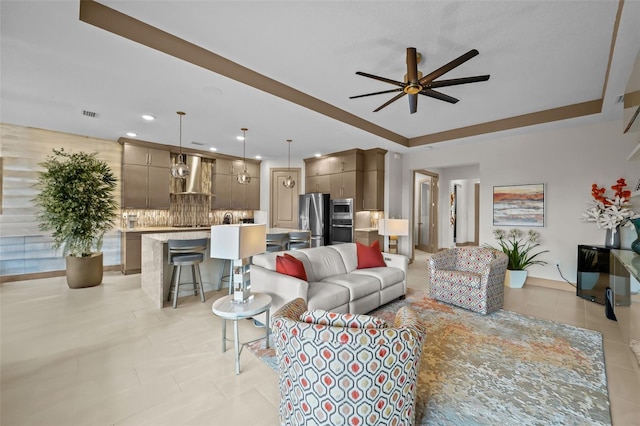 17702 Cresswind Ter, Bradenton, FL 34211 - living room with a ceiling fan, recessed lighting, light tile patterned flooring, and a raised ceiling