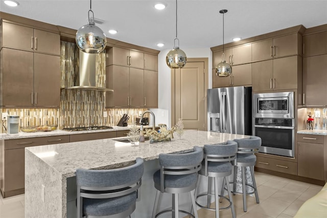 17702 Cresswind Ter, Bradenton, FL 34211 - kitchen featuring appliances with stainless steel finishes, backsplash, recessed lighting, a kitchen island with sink, and a breakfast bar area