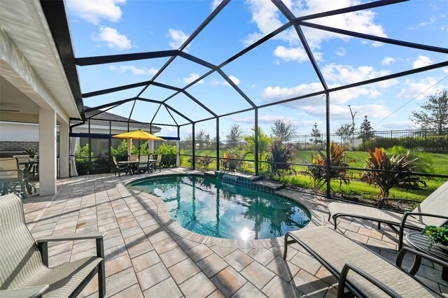 17702 Cresswind Ter, Bradenton, FL 34211 - outdoor pool featuring a patio area, outdoor dining space, and glass enclosure