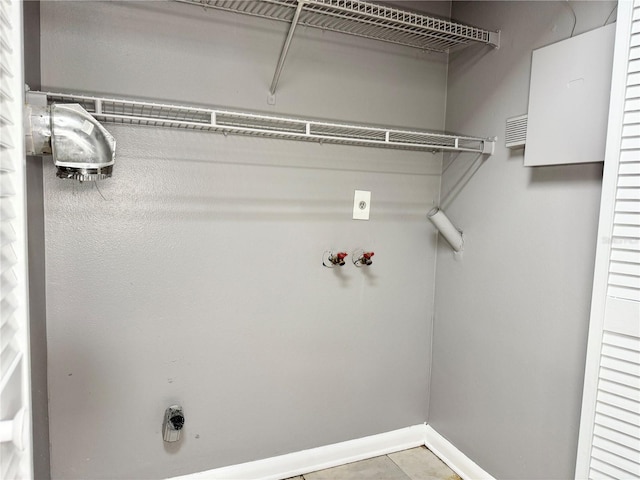 washroom with electric dryer hookup, light tile patterned floors, and hookup for a washing machine