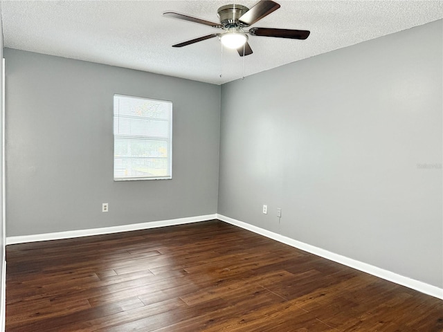 empty room with ceiling fan, dark hardwood / wood-style flooring, and a textured ceiling