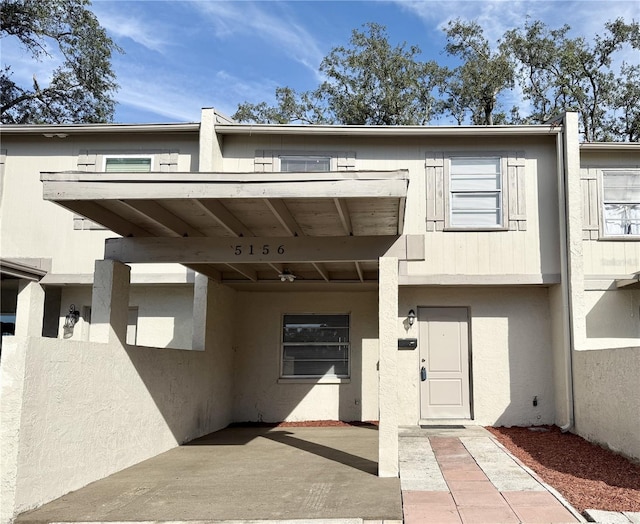 view of exterior entry with a patio