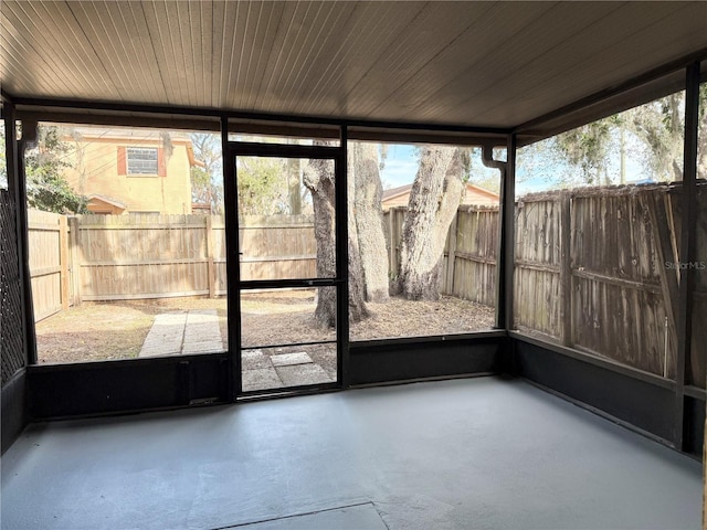 unfurnished sunroom with wooden ceiling